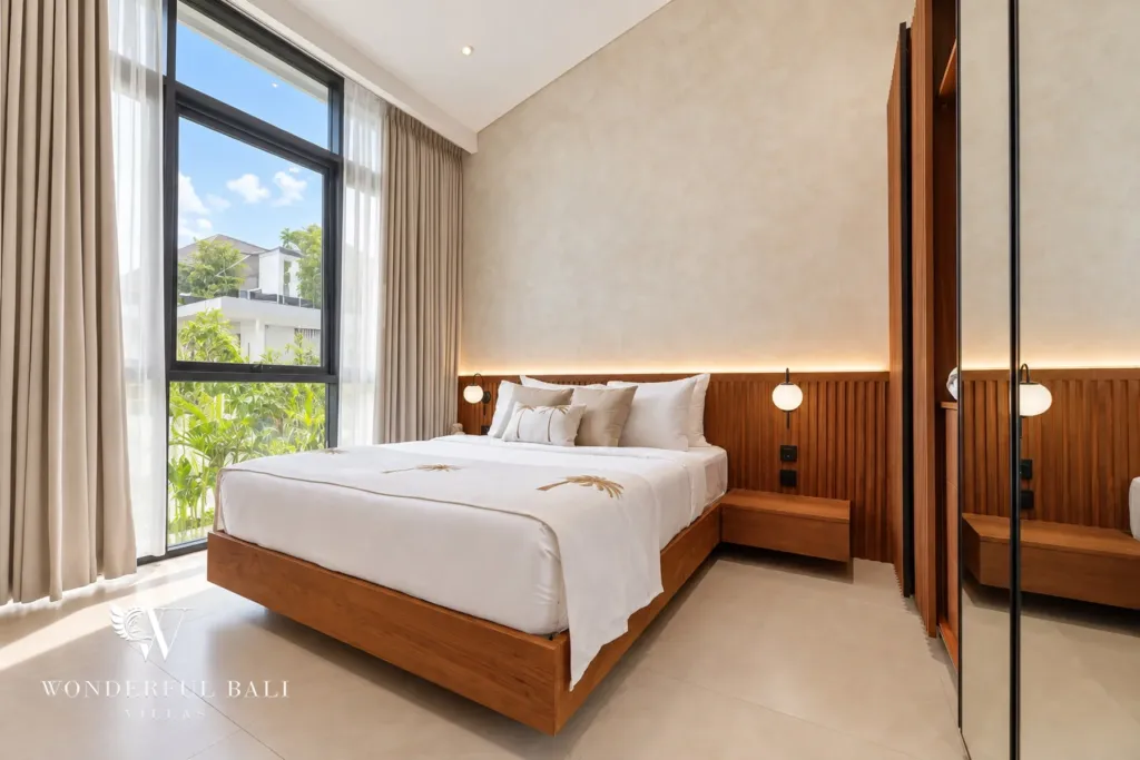 2BR villa for rent in Padonan, Canggu — bedroom, bedroom with floor-to-ceiling windows and a timber headboard
