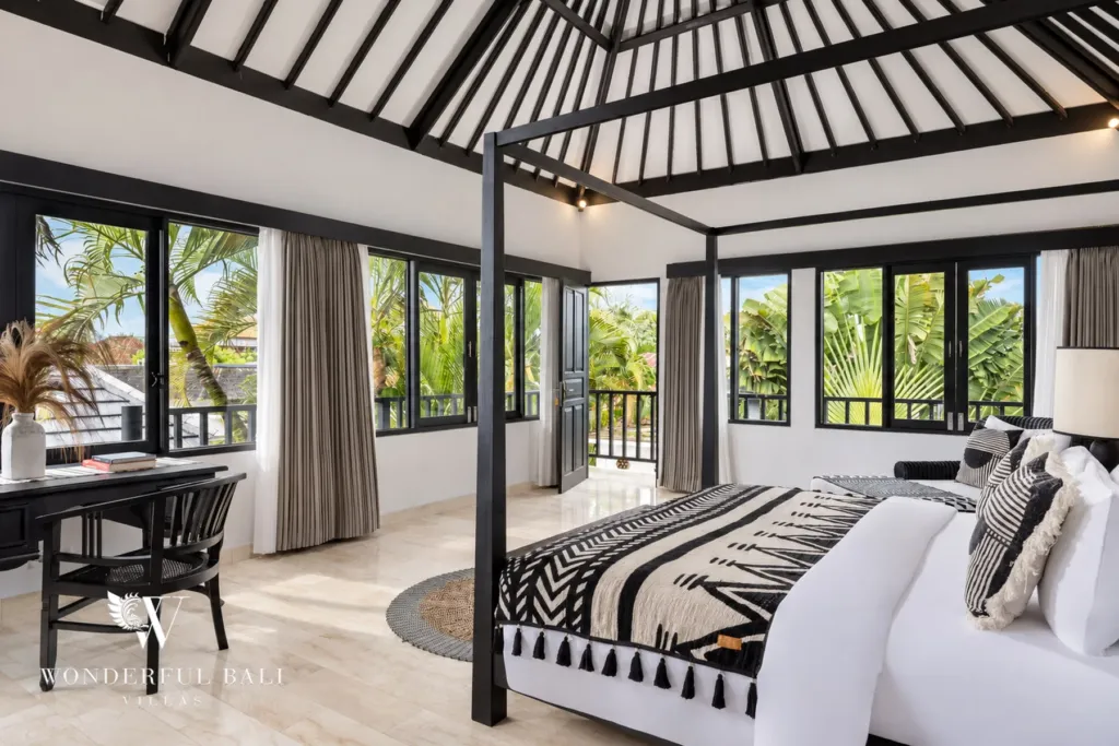 4BR villa for rent in Batu Bolong, Canggu — bedroom, four-poster bed with striped headboard under a vaulted black roof