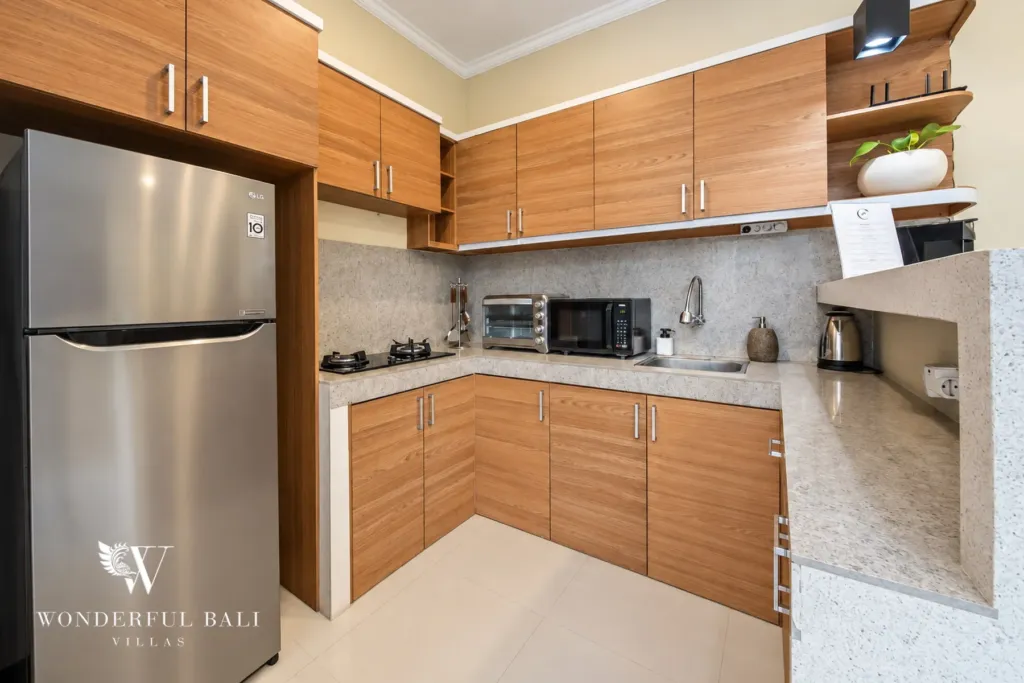 4BR villa for rent in Umalas, Bali — kitchen, fully equipped teak kitchen with a stone-clad breakfast bar