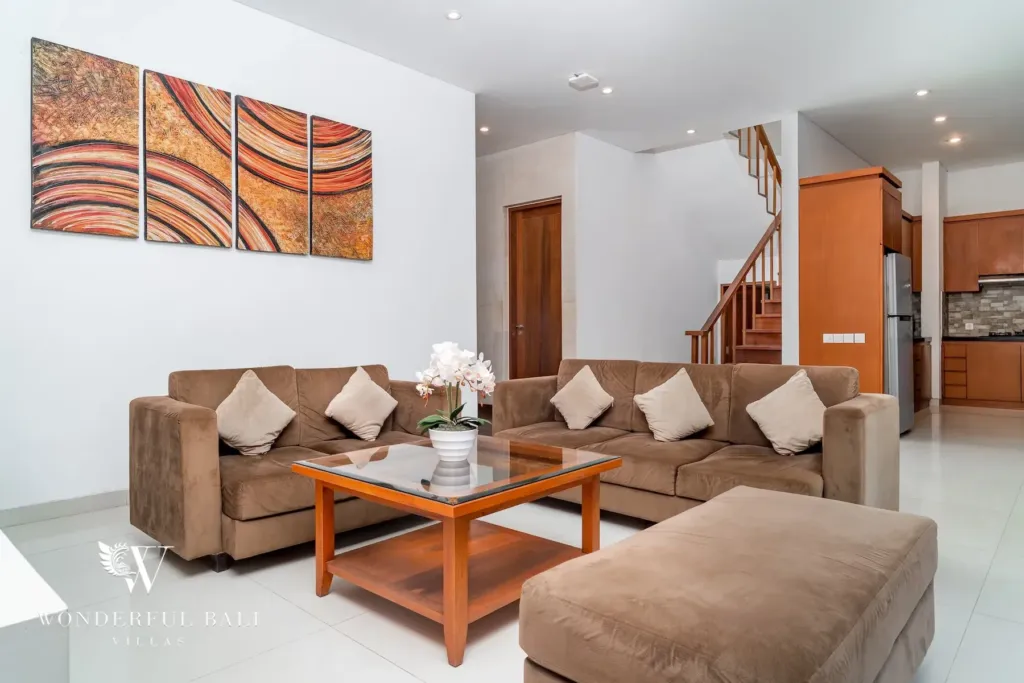 3BR villa for rent in Batu Belig, Seminyak — living room, ground-floor lounge opening to the garden through full-height glass