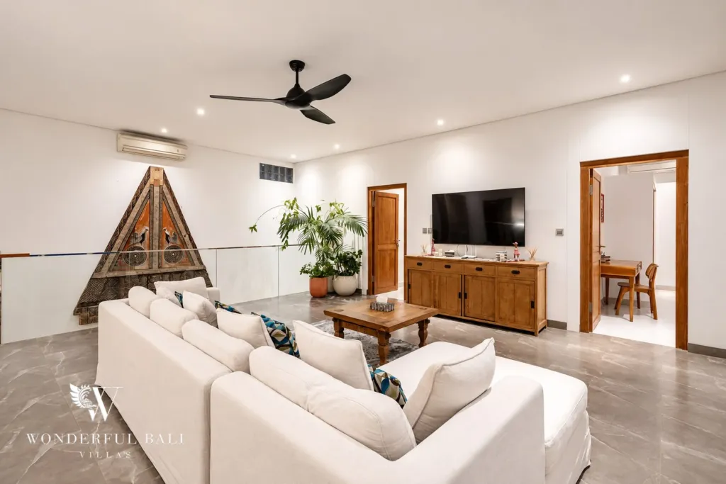 5BR villa for rent in Bumbak, Umalas — living room, second lounge with white sofas and a wall-mounted TV