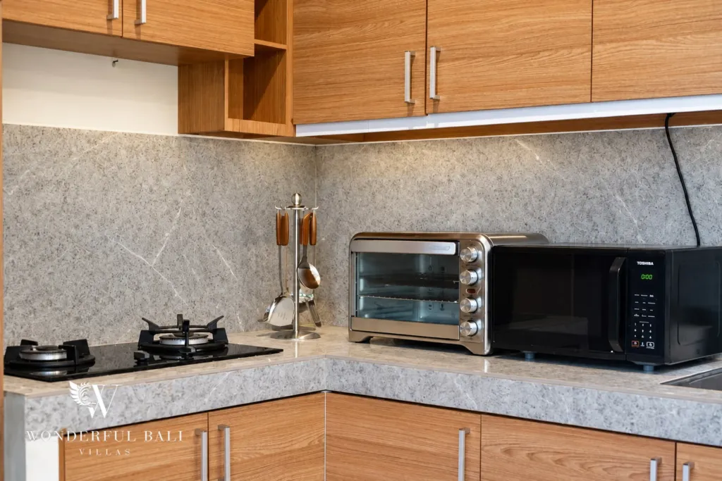 4BR villa for rent in Umalas, Bali — kitchen, teak cabinetry and open shelving in the kitchen
