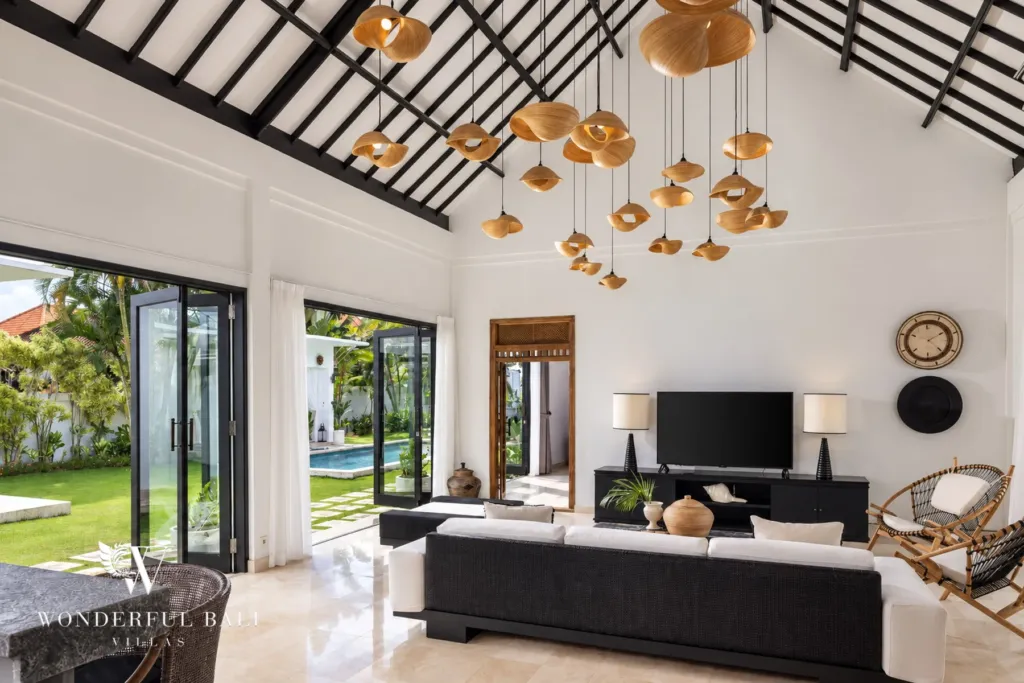 4BR villa for rent in Batu Bolong, Canggu — living room, living room open through sliding doors to the pool and lawn