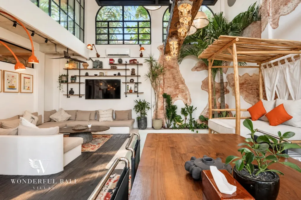 3BR villa for sale in Berawa — living room, open-plan living with shelving, daybed and tropical planting