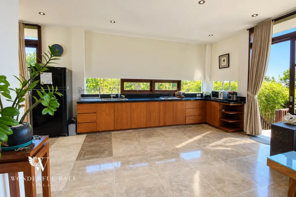 3BR villa for sale in Jimbaran — kitchen, L-shaped kitchen with timber cabinets and a black stone worktop