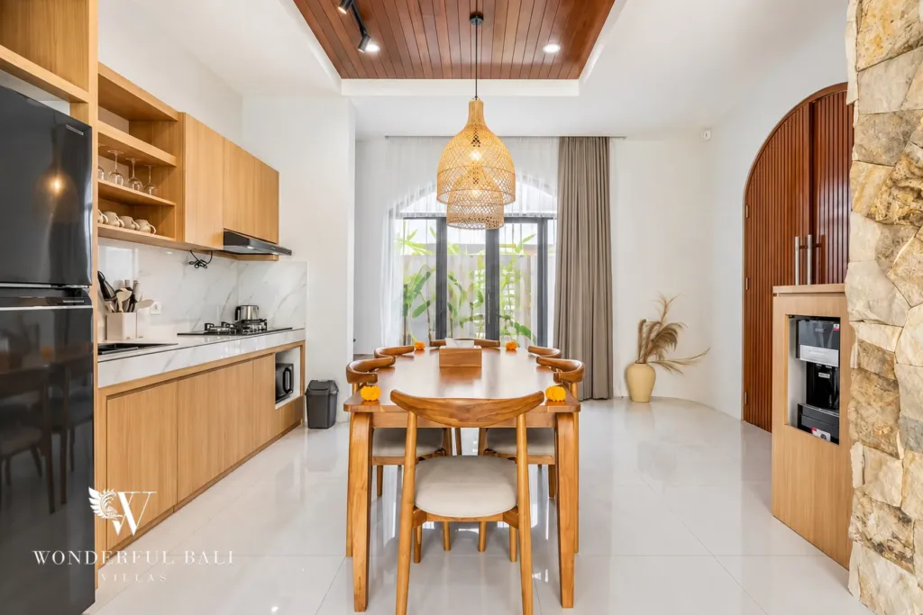 3BR villa for rent in Umalas, Bali — kitchen, timber kitchen and round dining table under a woven pendant