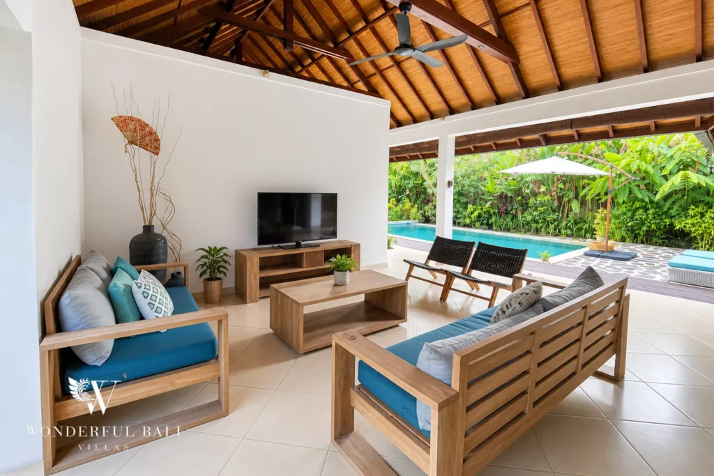 3BR villa for rent in Padonan, Canggu — living room, lounge seating open to the pool deck under the pitched roof