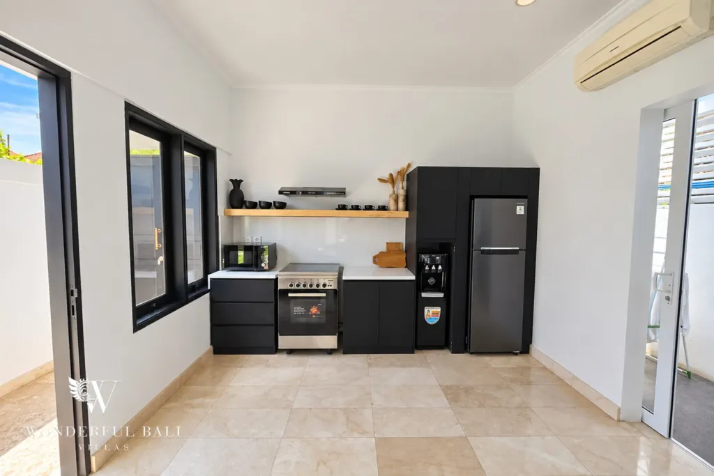 4BR villa for rent in Batu Bolong, Canggu — kitchen, compact service kitchen in black joinery with open shelving