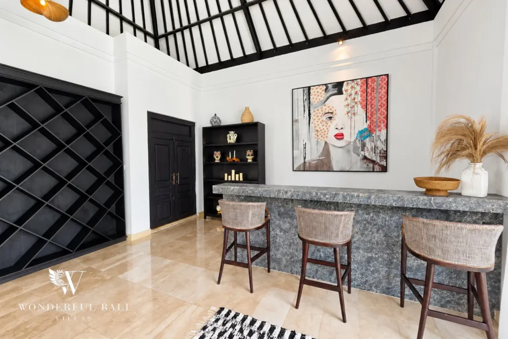 4BR villa for rent in Batu Bolong, Canggu — kitchen, stone bar counter with woven stools beside the lattice wall