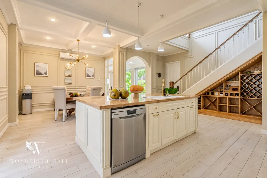 5BR villa for sale in Pererenan — kitchen island and wine rack under the staircase