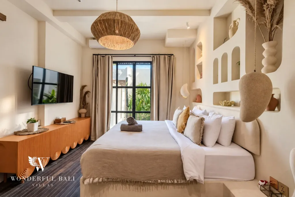 3BR villa for sale in Berawa — bedroom, bedroom with sculpted arched niches and garden doors