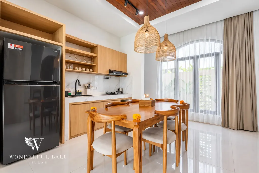 3BR villa for rent in Umalas, Bali — dining area, dining table and open shelving beside the kitchen run