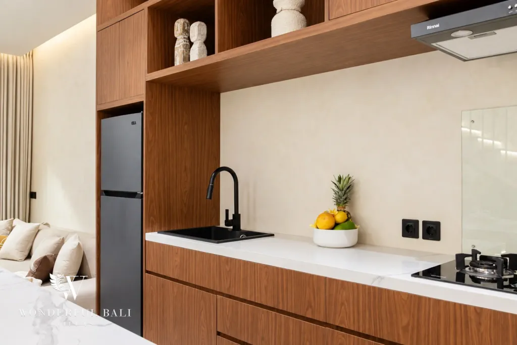 2BR villa for rent in Padonan, Canggu — kitchen, timber cabinetry, gas hob and fridge