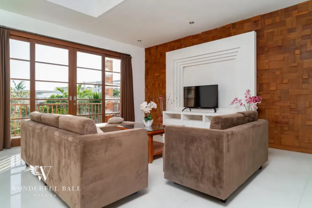 3BR villa for rent in Batu Belig, Seminyak — second lounge, upstairs lounge with balcony doors and a wall-mounted TV