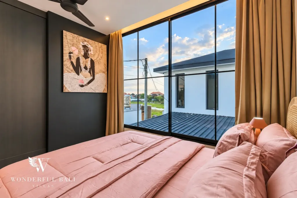 3BR villa for rent in Munggu — bedroom with dark feature wall and floor-to-ceiling window