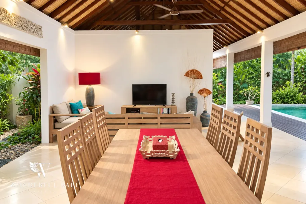 3BR villa for rent in Padonan, Canggu — dining area, long dining table with a red runner beside the living area