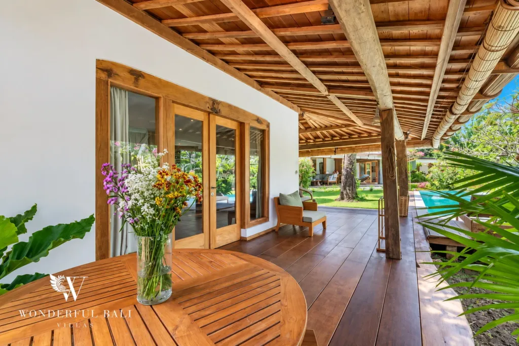 5BR villa for rent in Umalas — terrace, round teak table on the deck overlooking the garden
