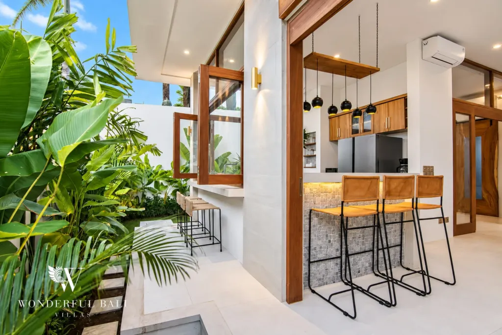 4BR villa for rent in Cemagi — kitchen, breakfast bar opening to a tropical garden passage