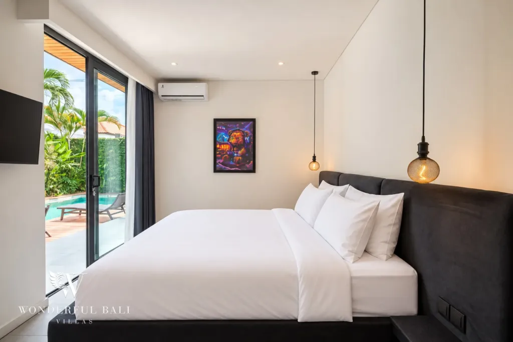 3br villa for sale umalas — poolside bedroom with a velvet headboard pendant lights and wall-mounted TV
