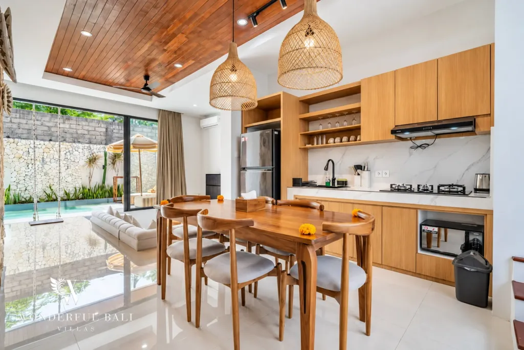 3BR villa for rent in Umalas, Bali — dining area, dining table with the pool visible through the sliding doors