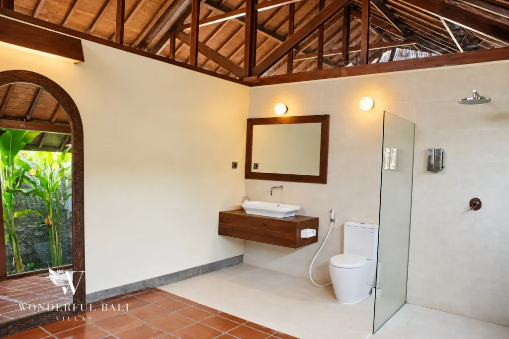 2BR villa for rent in Seseh — bathroom with walk-in rain shower and arched door