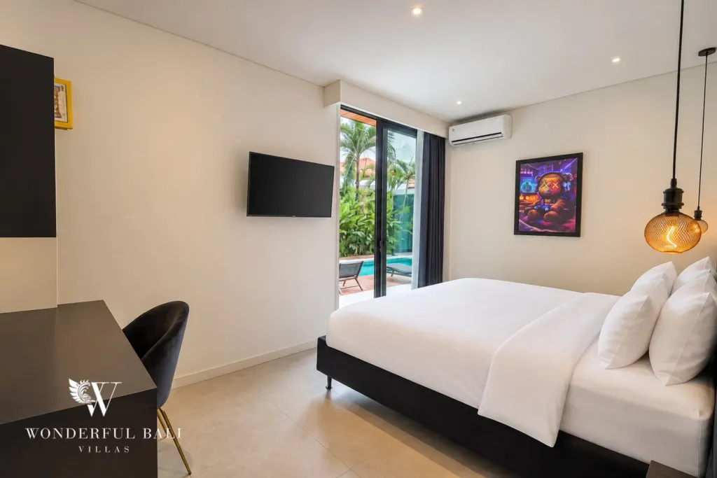 3br villa for sale umalas — bedroom with a built-in desk and sliding doors to the pool terrace