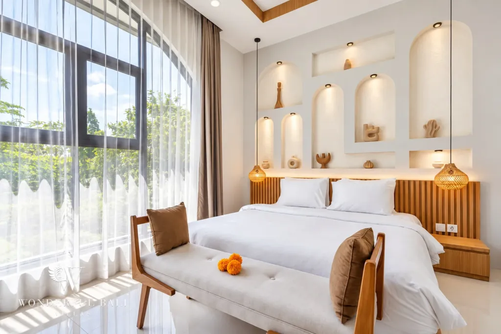 3BR villa for rent in Umalas, Bali — bedroom, bright bedroom with a fluted timber headboard and arched window