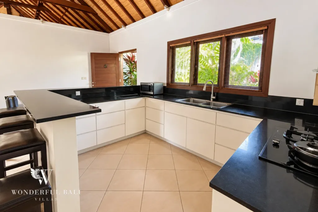 3BR villa for rent in Padonan, Canggu — kitchen, fitted kitchen with black granite counters and garden windows