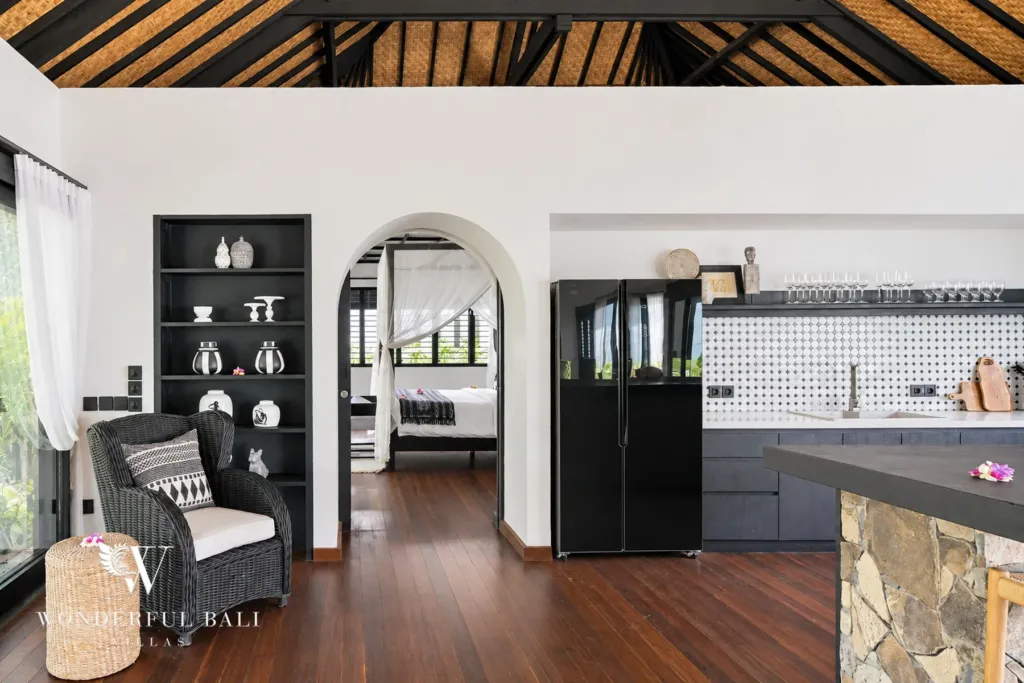 5BR villa for rent in Munggu, Bali — kitchen, fitted kitchen with a stone breakfast bar and black joinery