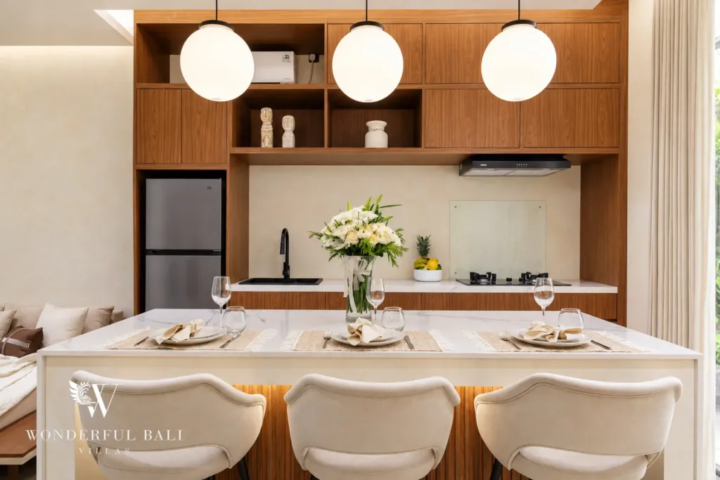 2BR villa for rent in Padonan, Canggu — kitchen, marble island set for dinner under pendant lights