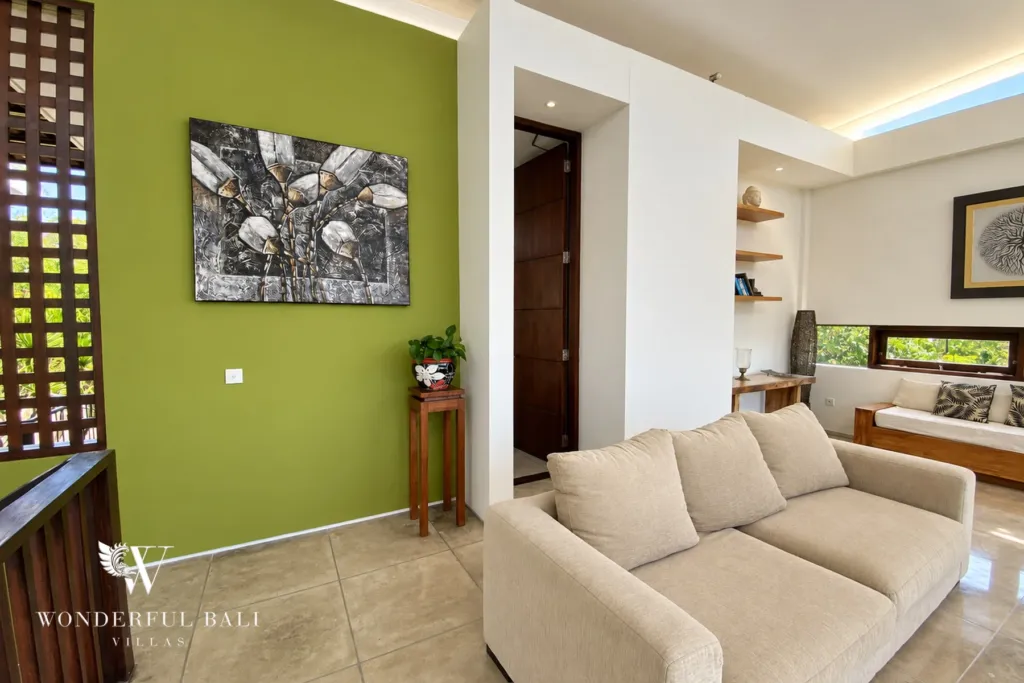 3BR villa for sale in Jimbaran — living room, lounge corner with a green feature wall and carved screen