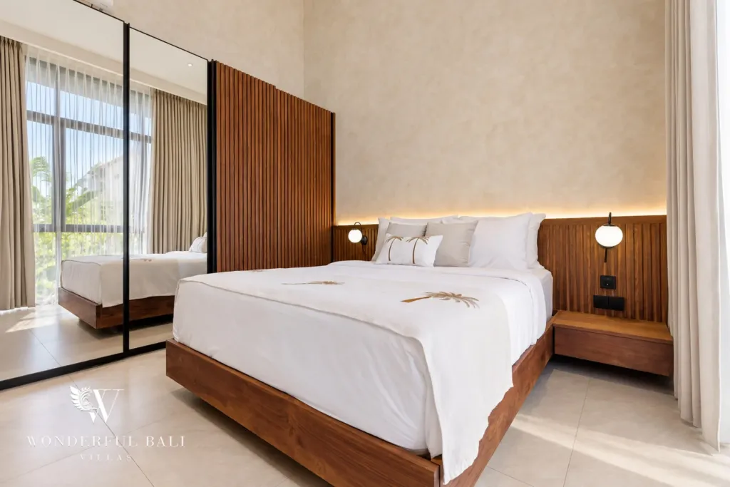 2BR villa for rent in Padonan, Canggu — bedroom, bedroom with a mirrored wardrobe and warm headboard lighting