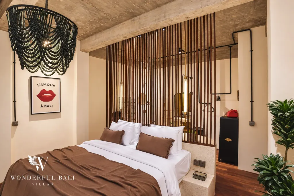2BR villa for rent in Berawa, Canggu — bedroom, framed travel posters, beaded pendant and a timber batten headboard wall