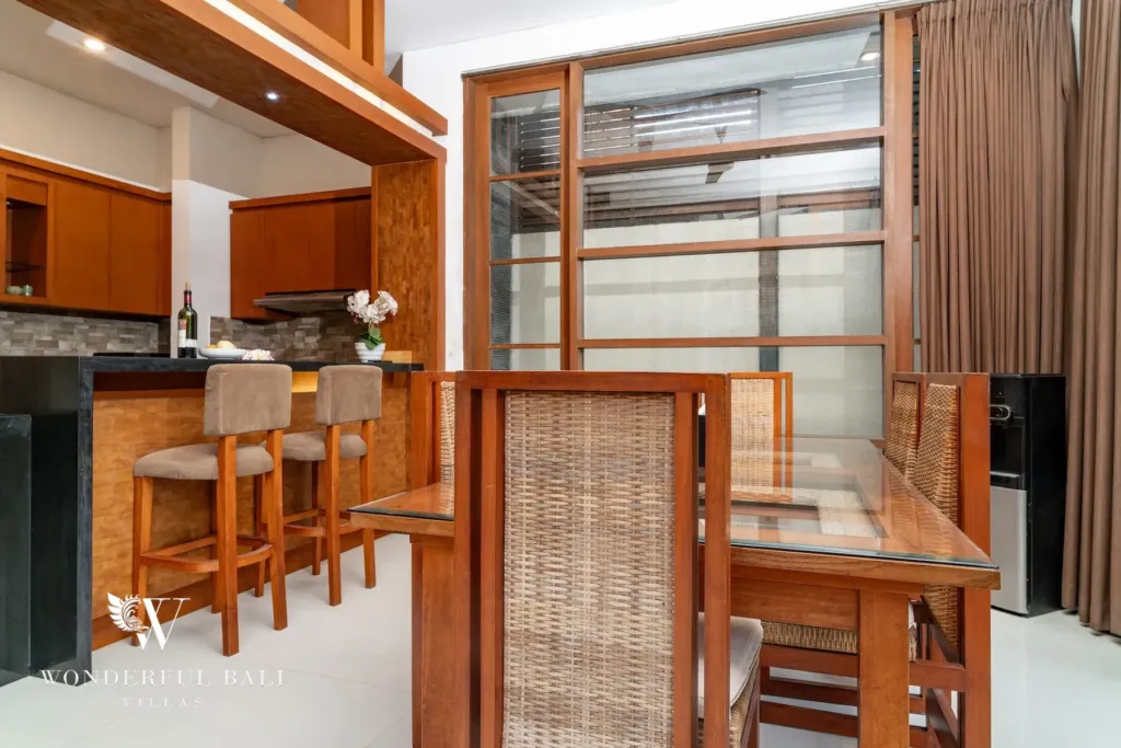 3BR villa for rent in Batu Belig, Seminyak — dining room, dining table beside the granite breakfast bar and timber stools