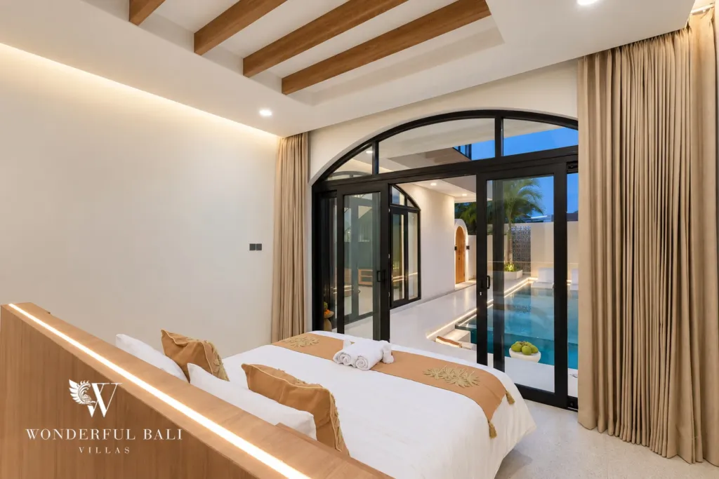 3BR villa for rent in Berawa, Canggu — bedroom, bedroom with a beamed ceiling and sliding doors onto the pool