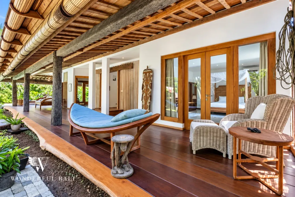 5BR villa for rent in Umalas — terrace, carved daybed and wicker chairs outside a bedroom