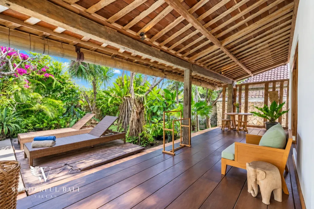 5BR villa for rent in Umalas — terrace, sun loungers on a covered deck facing the tropical garden