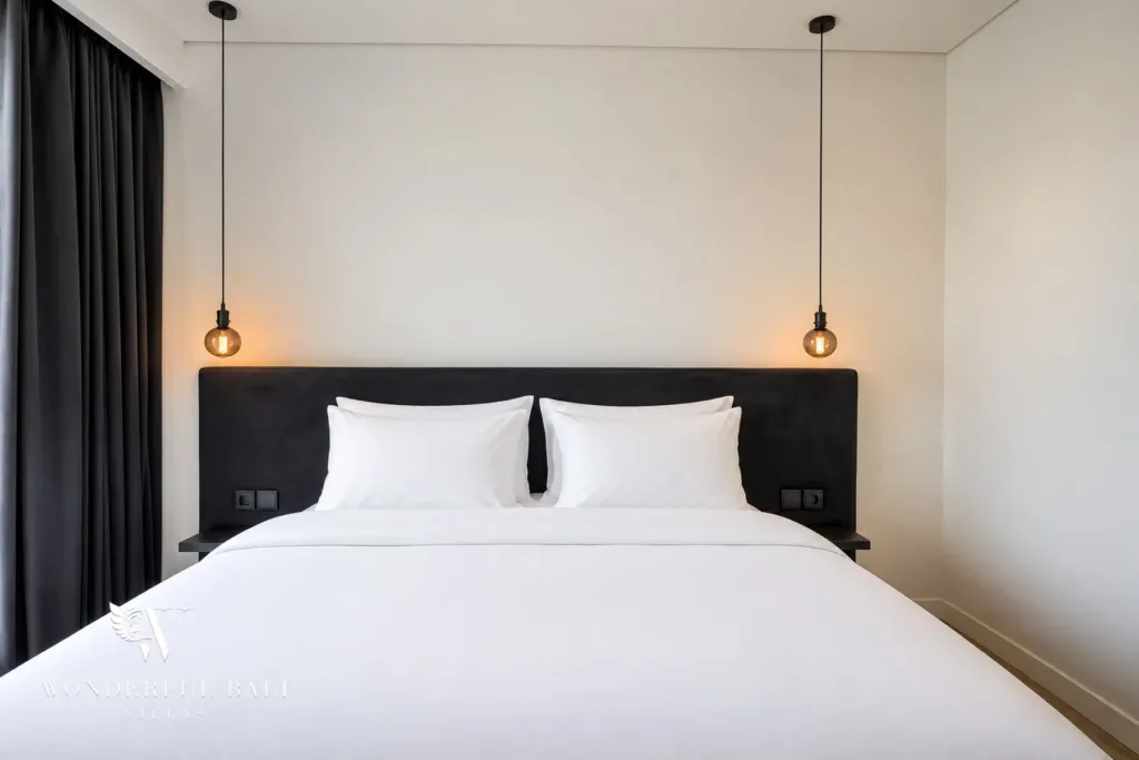3br villa for sale umalas — velvet headboard with hanging pendant bulbs and built-in bedside shelves