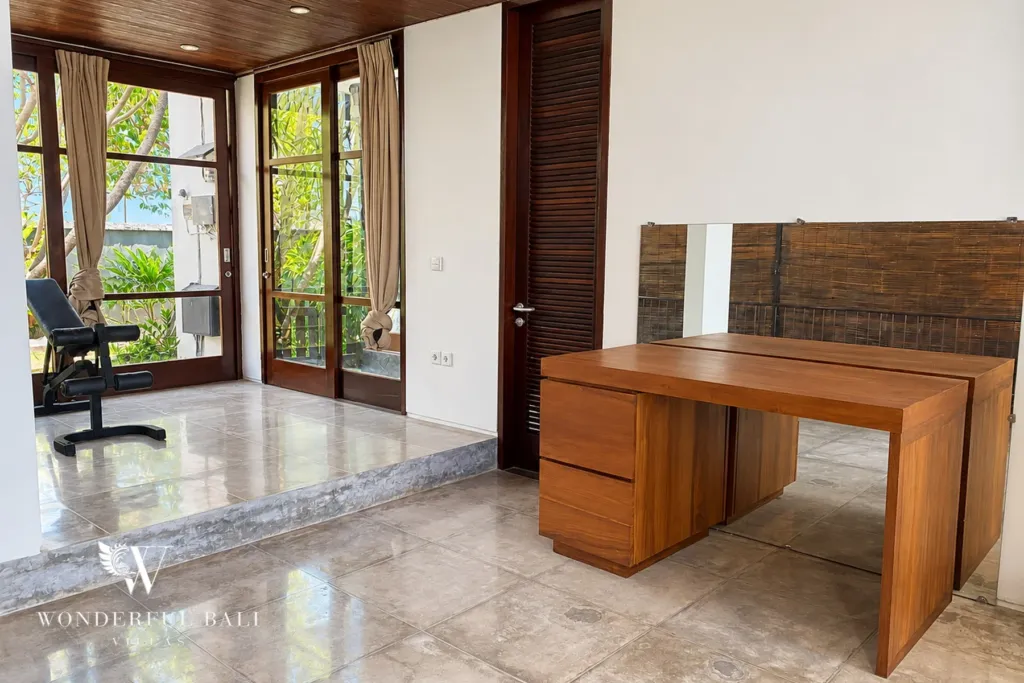 3BR villa for sale in Jimbaran — workspace, home office desk with a gym bench by the garden doors