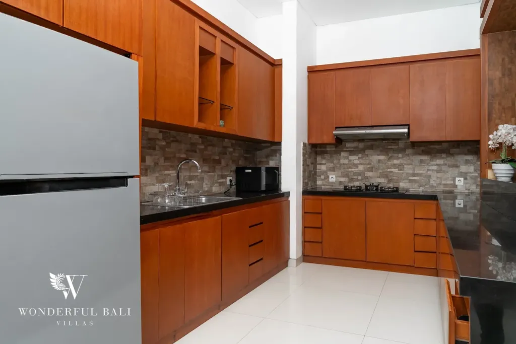 3BR villa for rent in Batu Belig, Seminyak — kitchen, fitted kitchen with timber cabinets and black granite counters