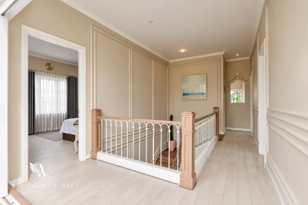 5BR villa for sale in Pererenan — upstairs landing with panelled walls leading to the bedrooms