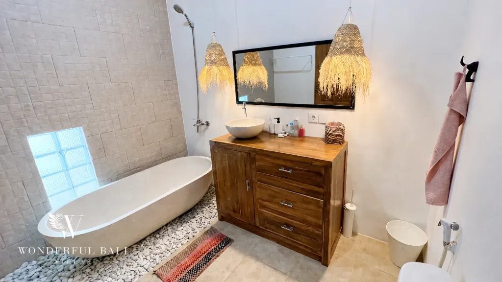 3BR villa for rent in Umalas — bathroom 3, tub and vanity under rattan pendants