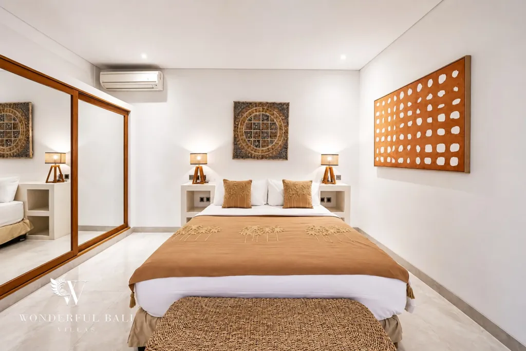 5BR villa for rent in Bumbak, Umalas — bedroom, bedroom with a carved timber wall panel above the bed