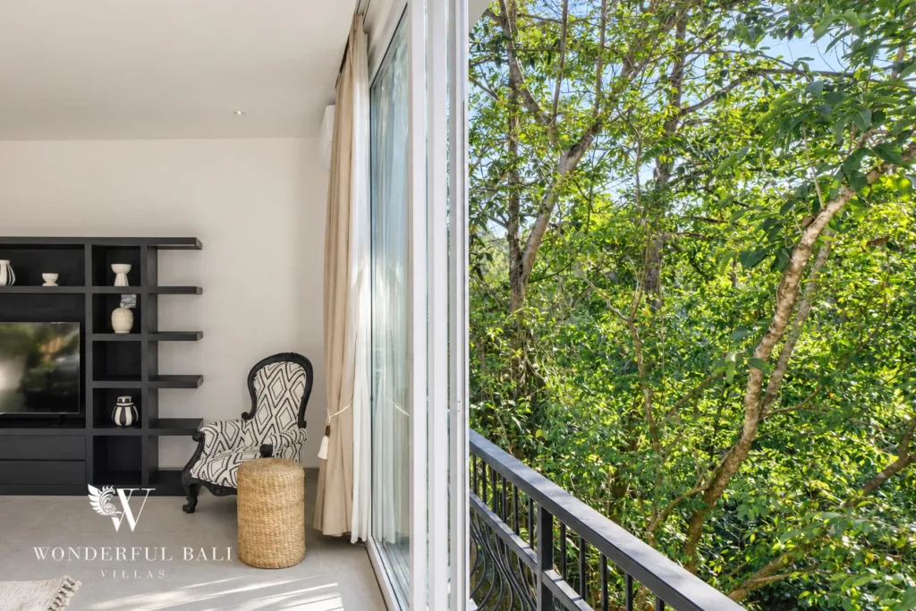 5BR villa for rent in Munggu, Bali — bedroom, bedroom opening to a private balcony over the treetops