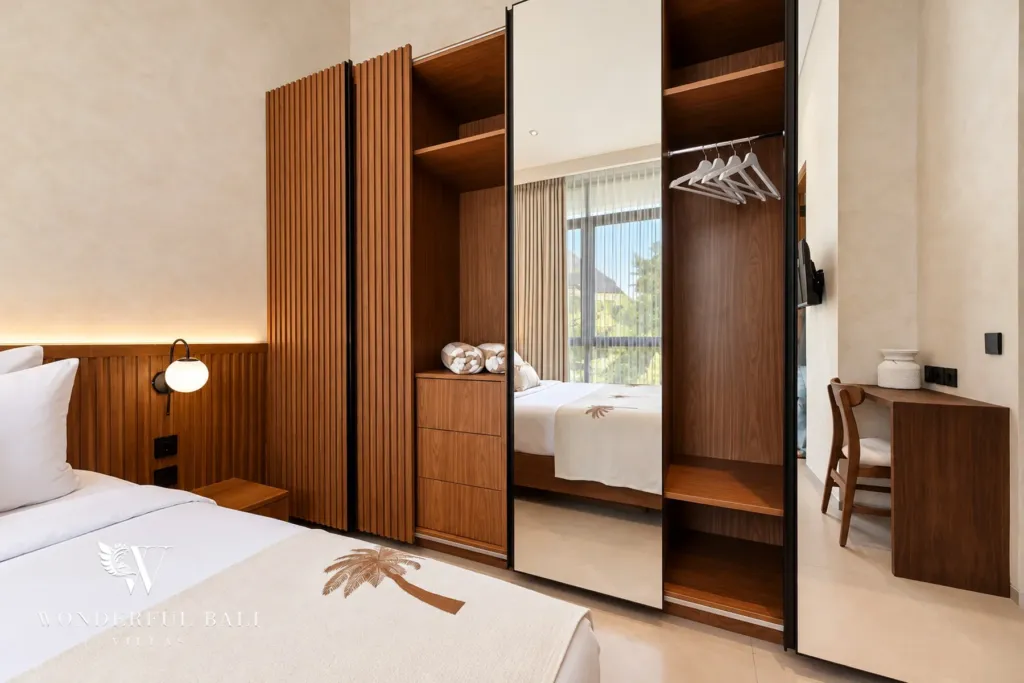 2BR villa for rent in Padonan, Canggu — bedroom, open timber wardrobe beside mirrored doors