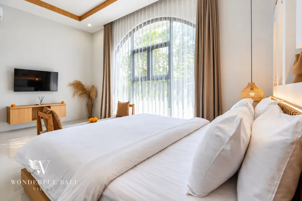 3BR villa for rent in Umalas, Bali — bedroom, bedroom with a tall arched window and rattan pendant light