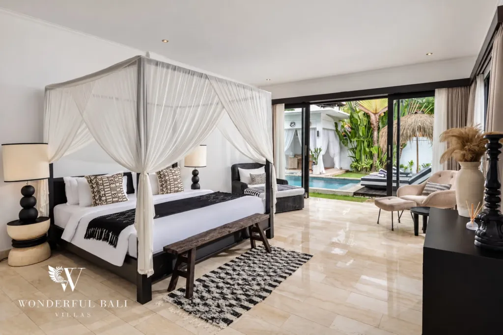 4BR villa for rent in Batu Bolong, Canggu — bedroom, four-poster canopy bed with sliding doors out to the pool