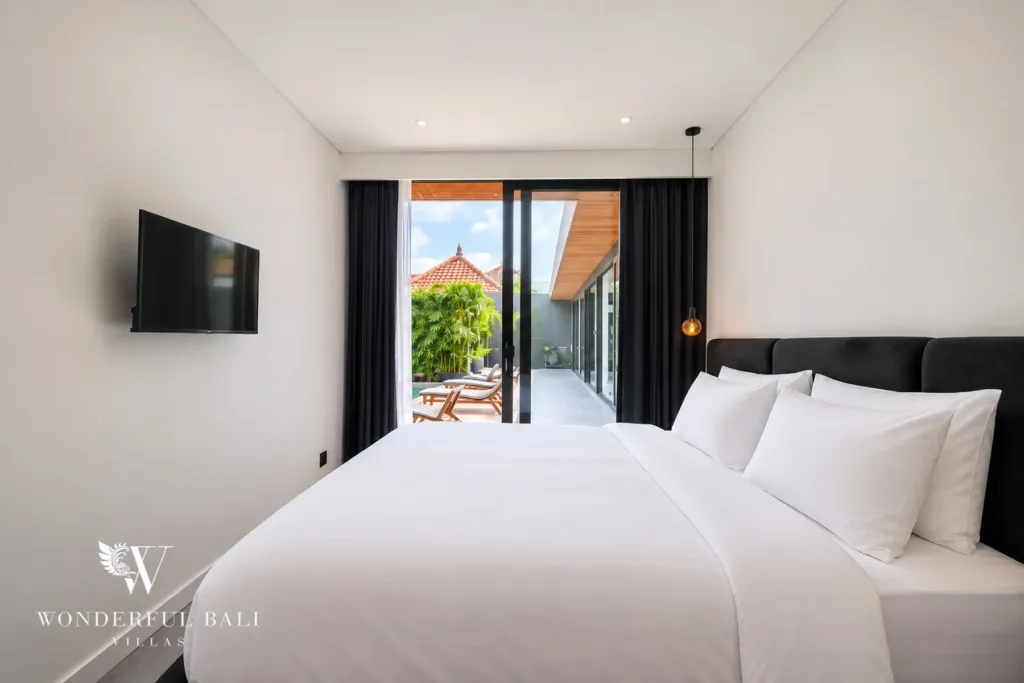 3br villa for sale umalas — bedroom looking down the pool terrace toward the planted courtyard