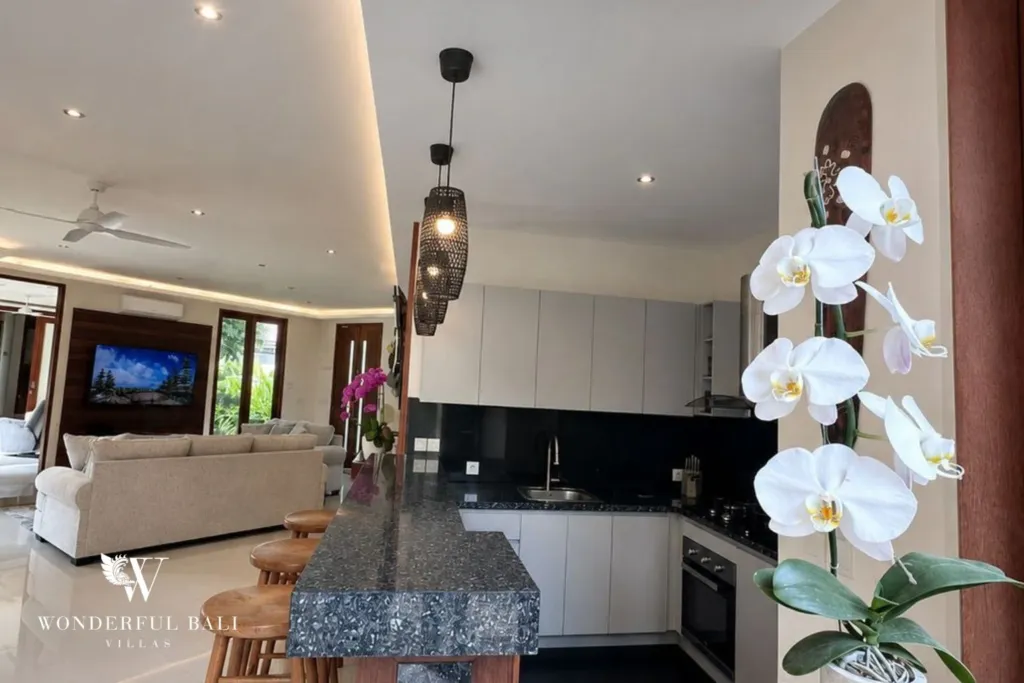 4BR villa for rent in Padonan, Canggu — kitchen, granite island with the living area beyond