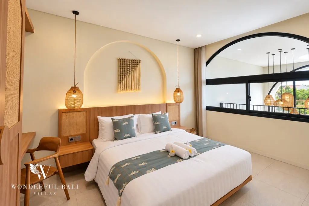 3BR villa for rent in Berawa, Canggu — bedroom, bedroom with a rattan headboard, desk and arched alcove